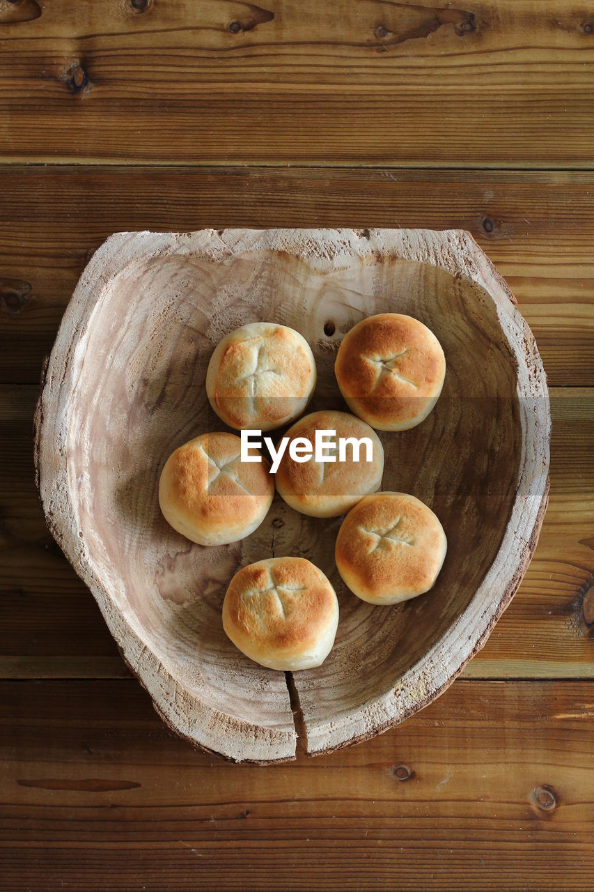 HIGH ANGLE VIEW OF BREAD ON WOODEN TABLE