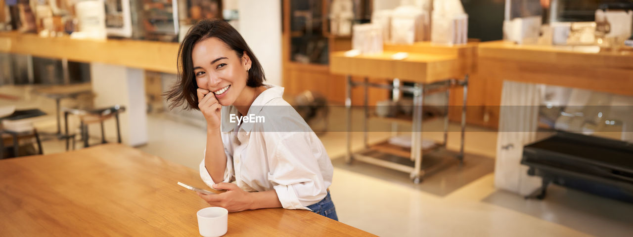 portrait of young woman standing in gym