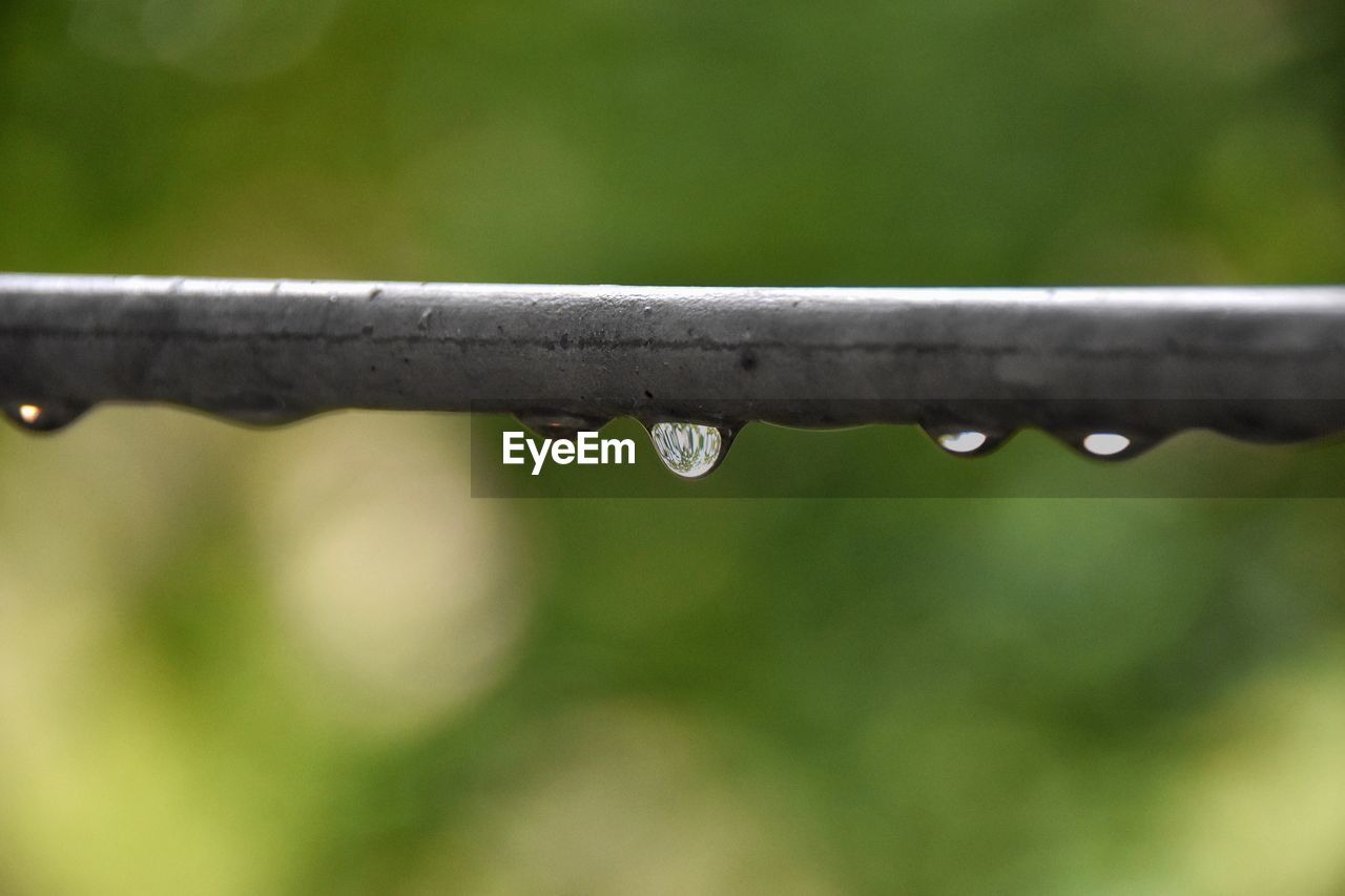 CLOSE-UP OF WATER DROP ON METAL