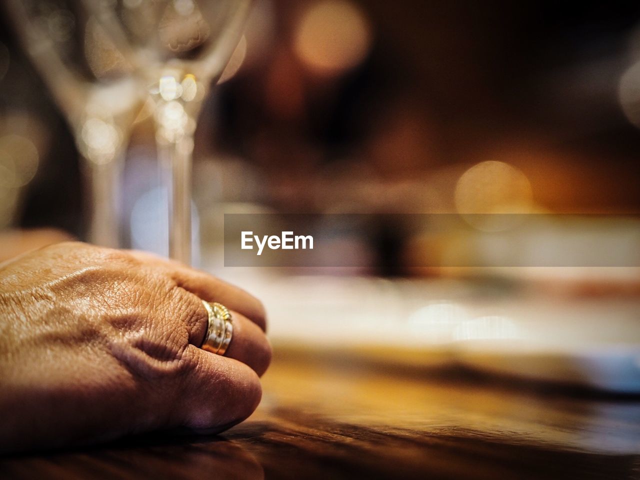 Cropped image of person by drink on bar