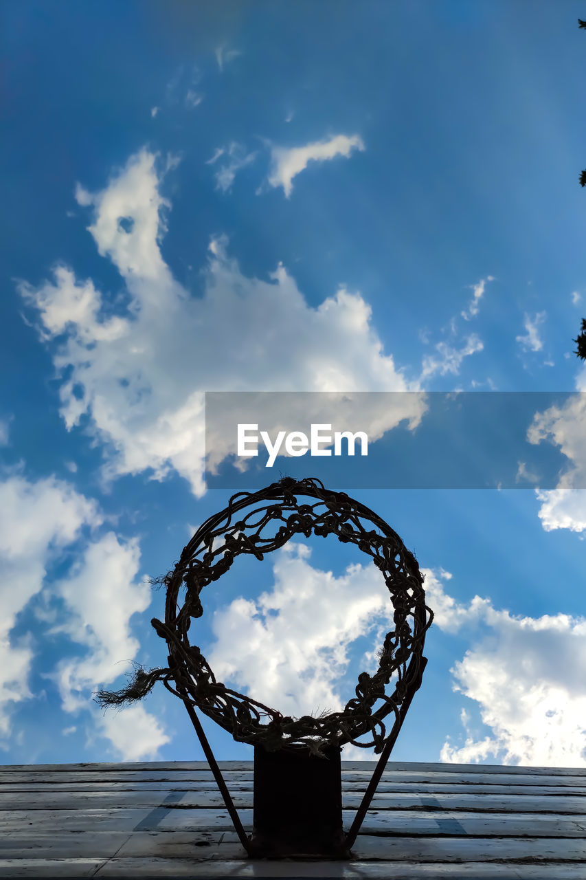 LOW ANGLE VIEW OF BASKETBALL AGAINST SKY