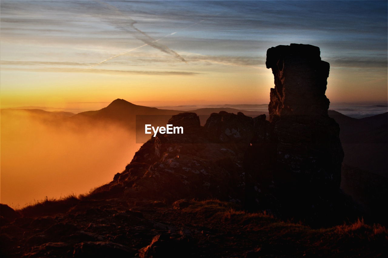 Scenic view of rock formation against sky during sunset