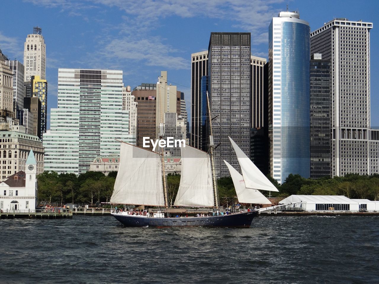 Sailboat on river against financial district