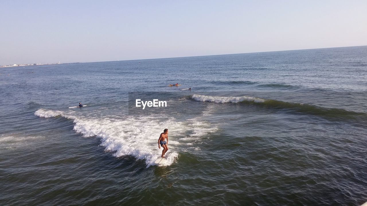 MAN SURFING IN SEA