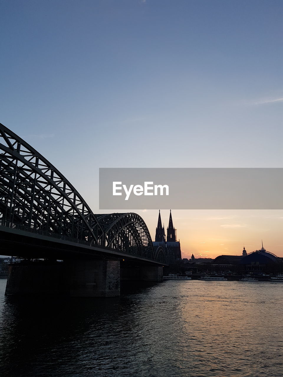 View of bridge in city at sunset