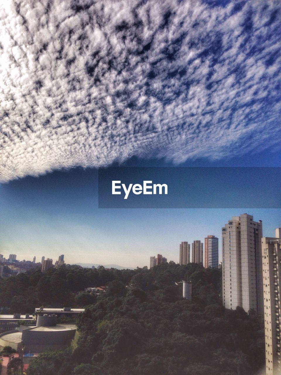 Buildings against cloudy sky