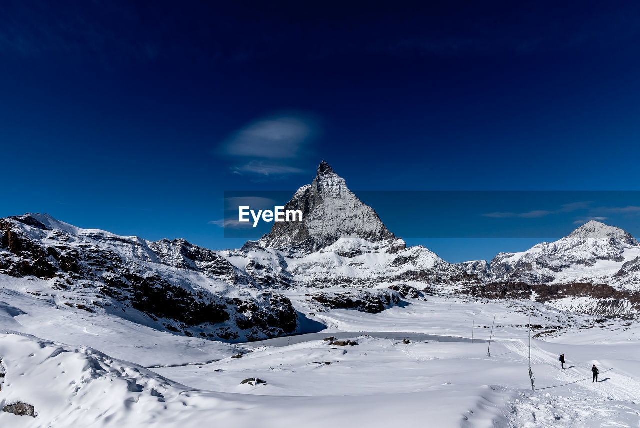 Snowcapped mountains against blue sky