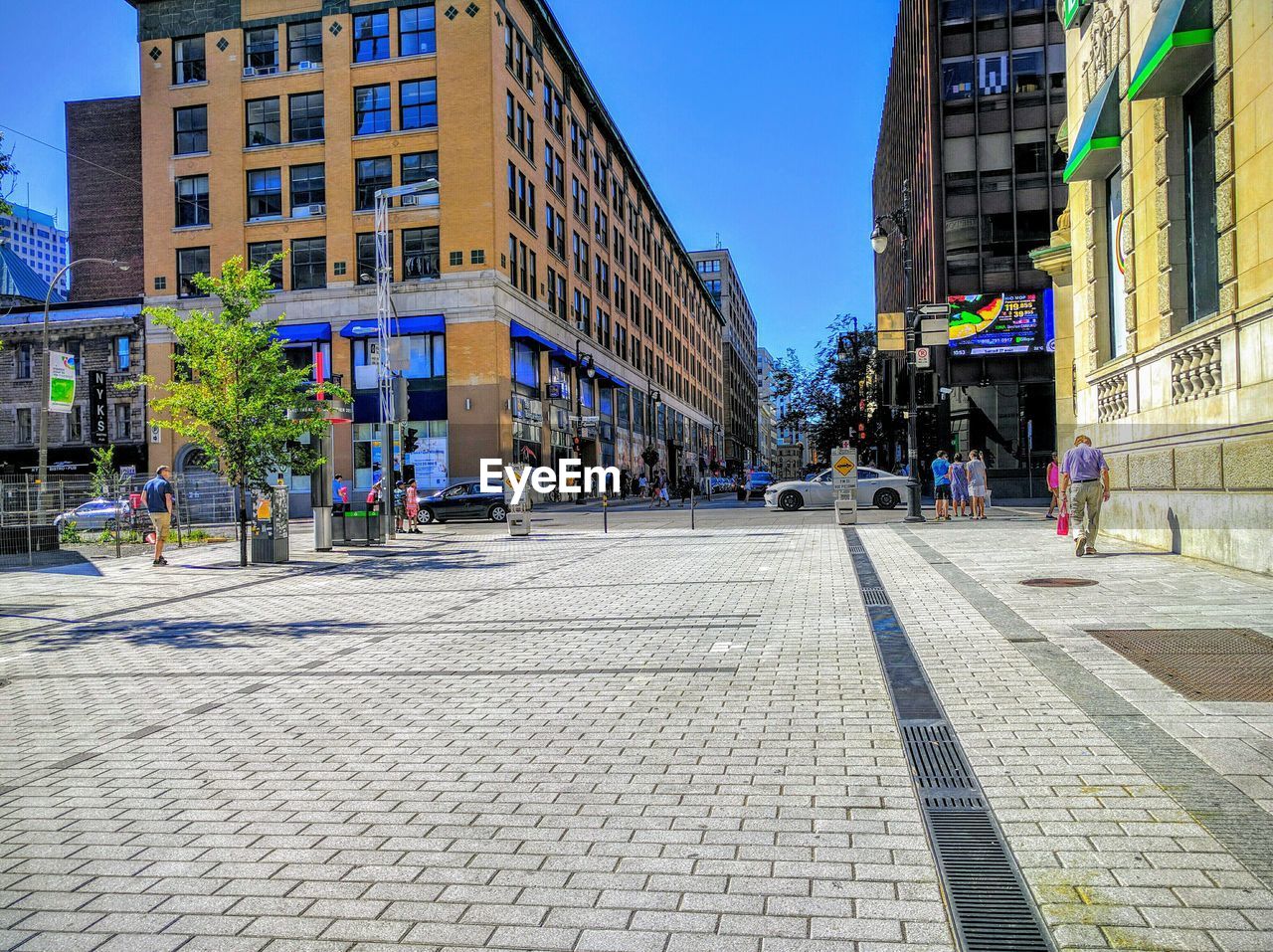 View of city street and buildings against sky