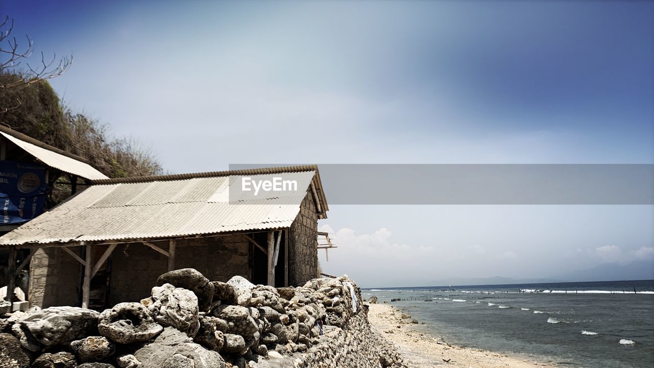 Built structure on beach against sky