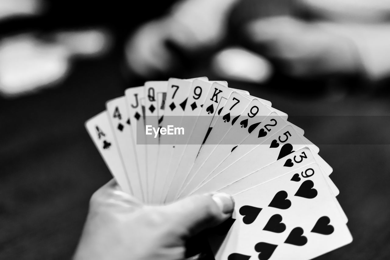 Close-up of hand holding cards