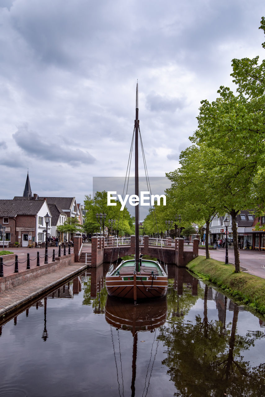 View of river by building against sky