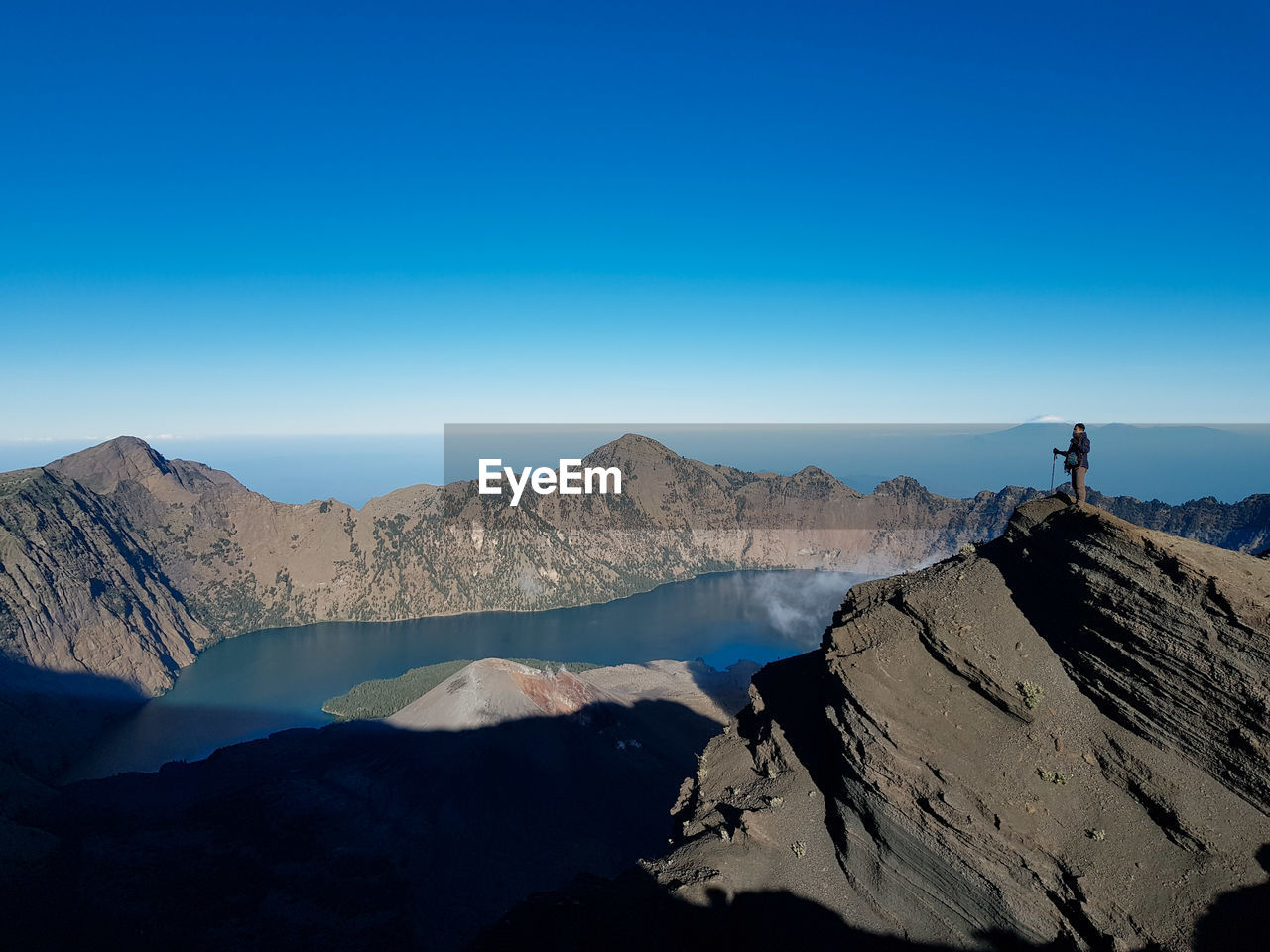 Scenic view of mountains against clear blue sky