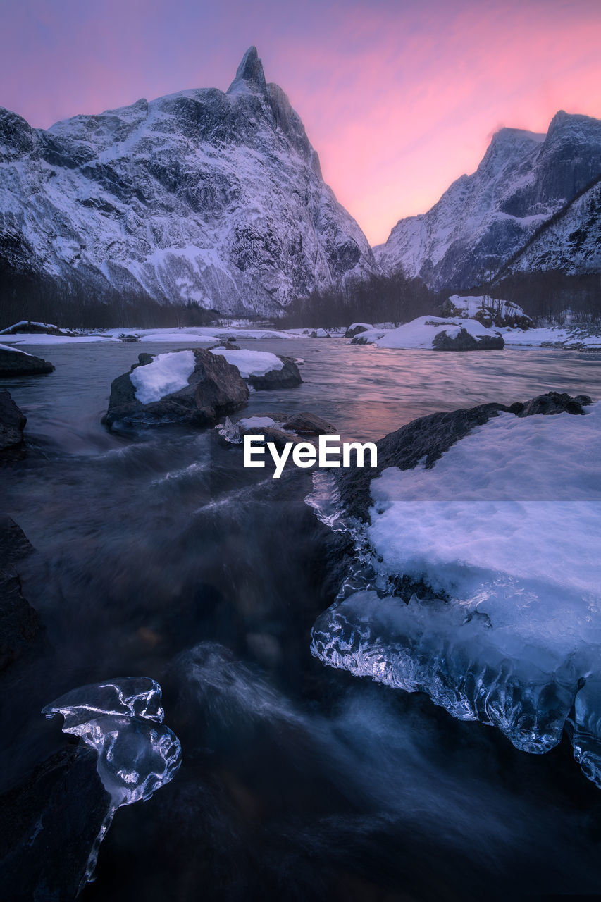 Beautiful colorful sunset in winter  overlooking the romsdalhorn and the rauma river in norway