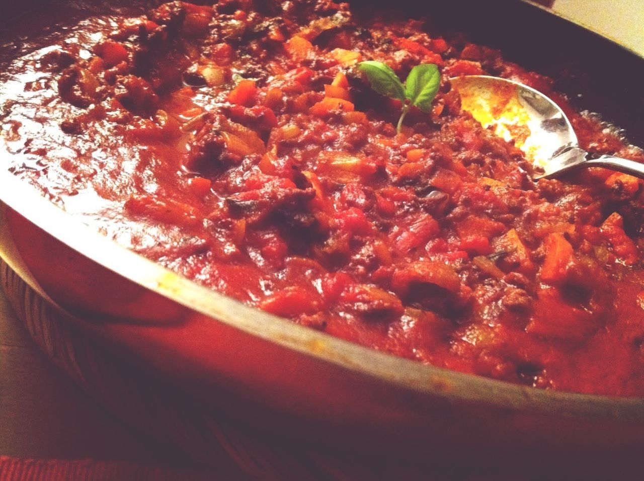 Close-up of bolognese sauce in pan served on table