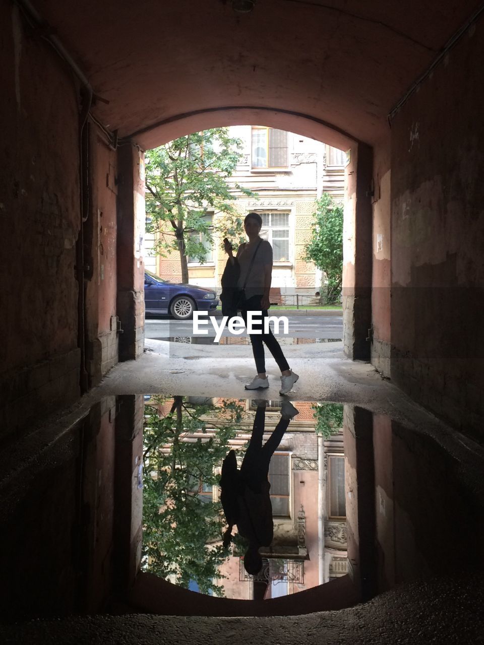 PEOPLE WALKING IN CORRIDOR OF BUILDING