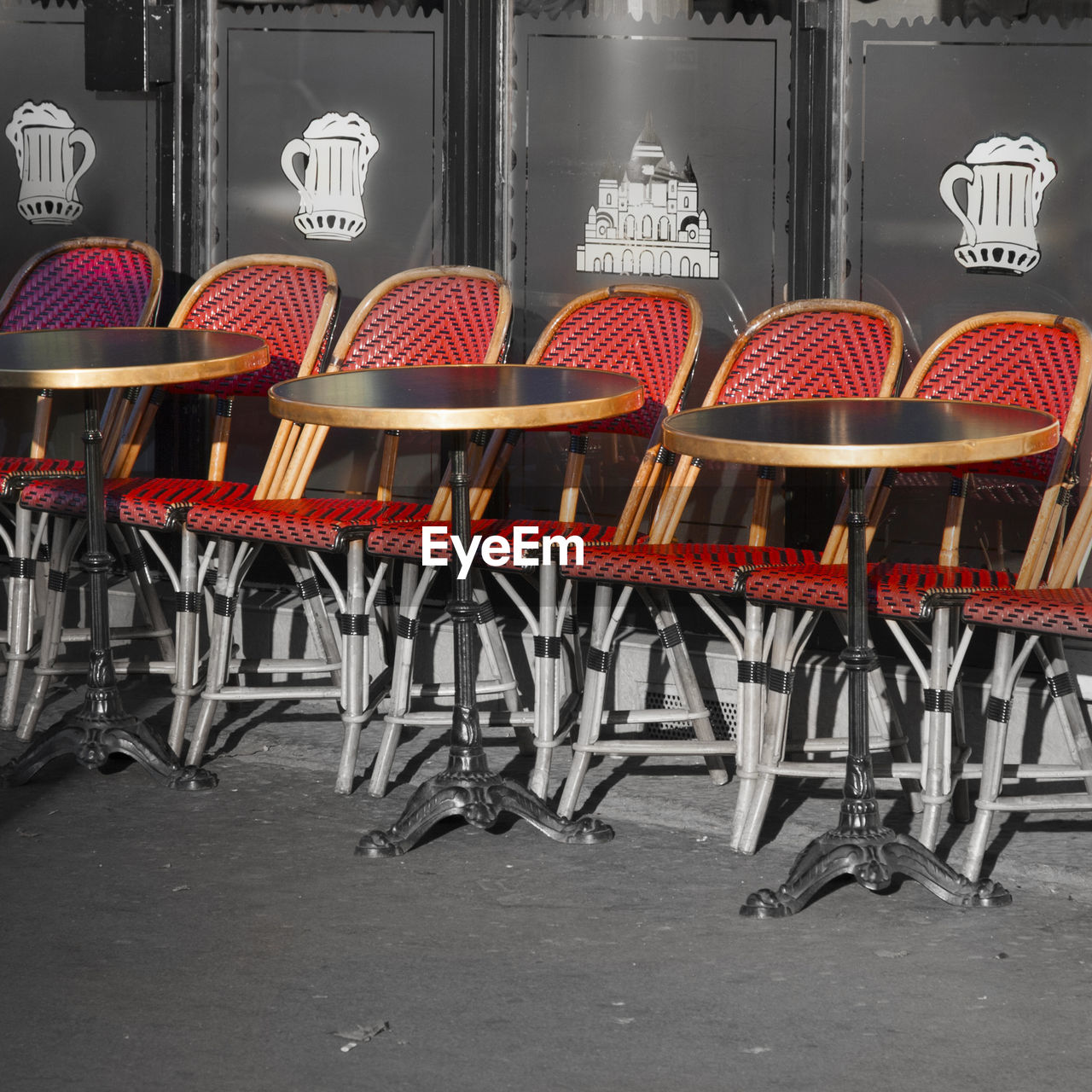 EMPTY CHAIRS AND TABLES IN CAFE AGAINST BUILDINGS