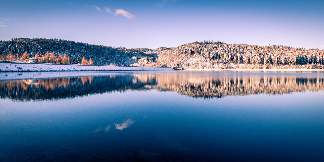 Scenic view of lake against sky during winter