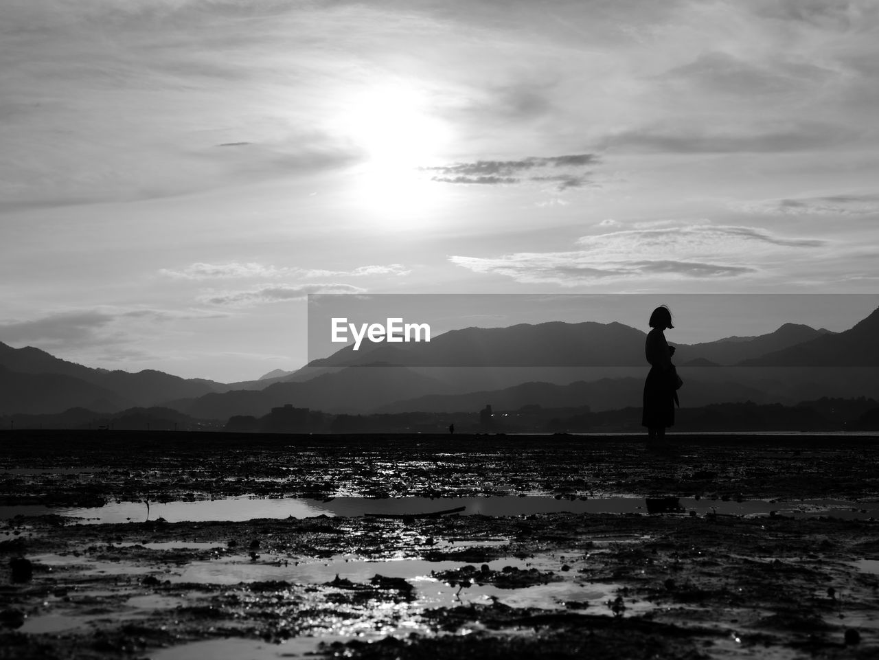 Silhouette man standing on mountain against sky during sunset