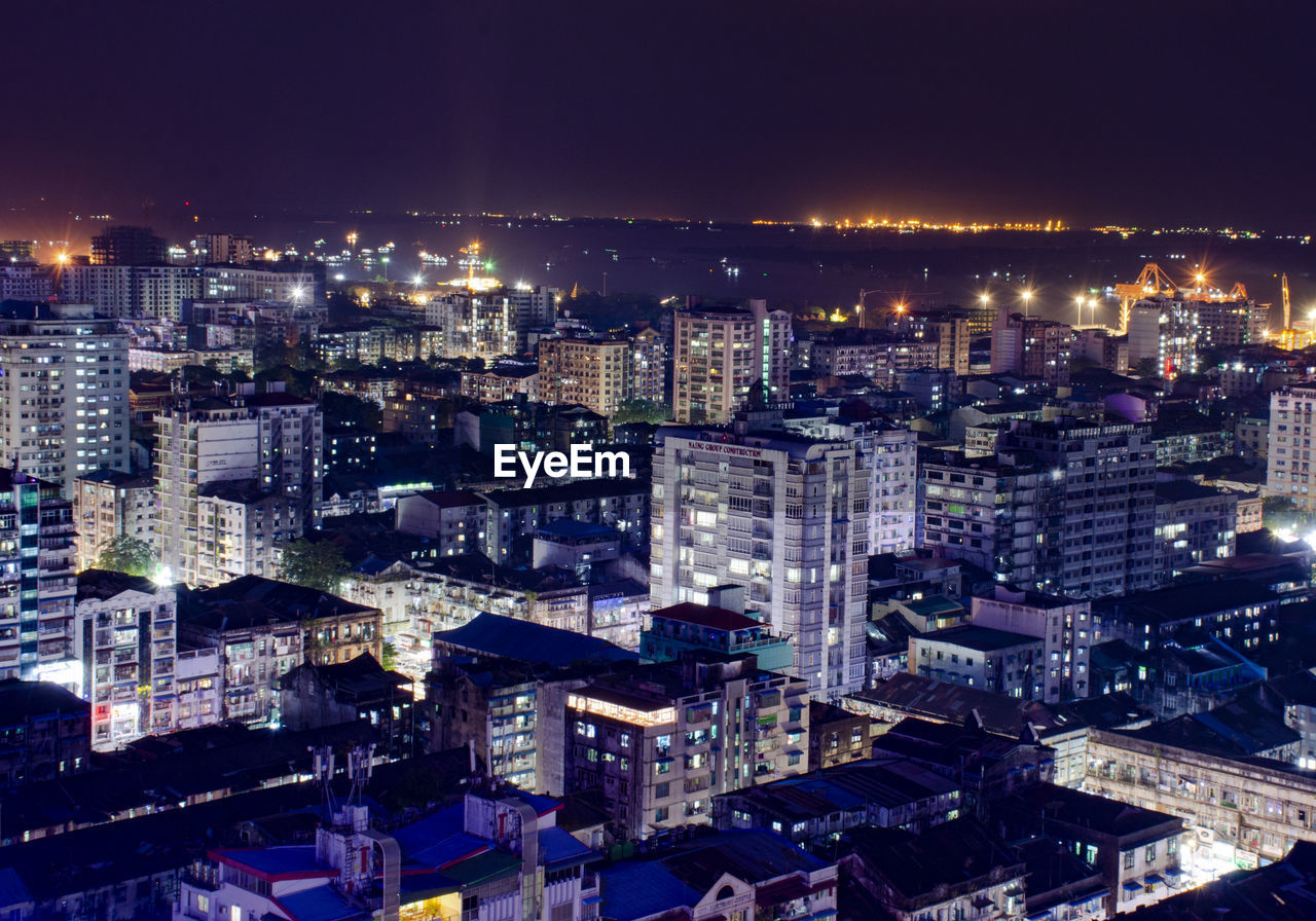 High angle view of illuminated buildings in city at night