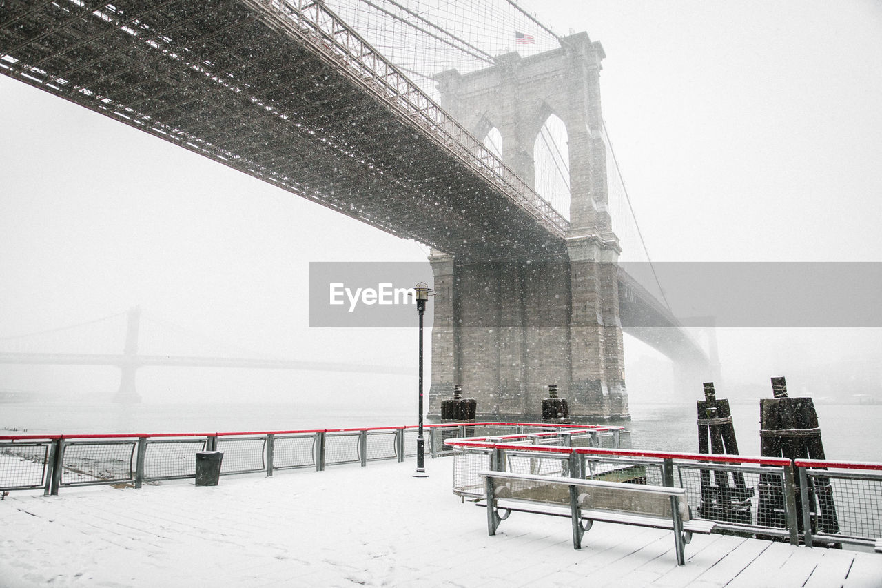 Low angle view of brooklyn bridge in winter
