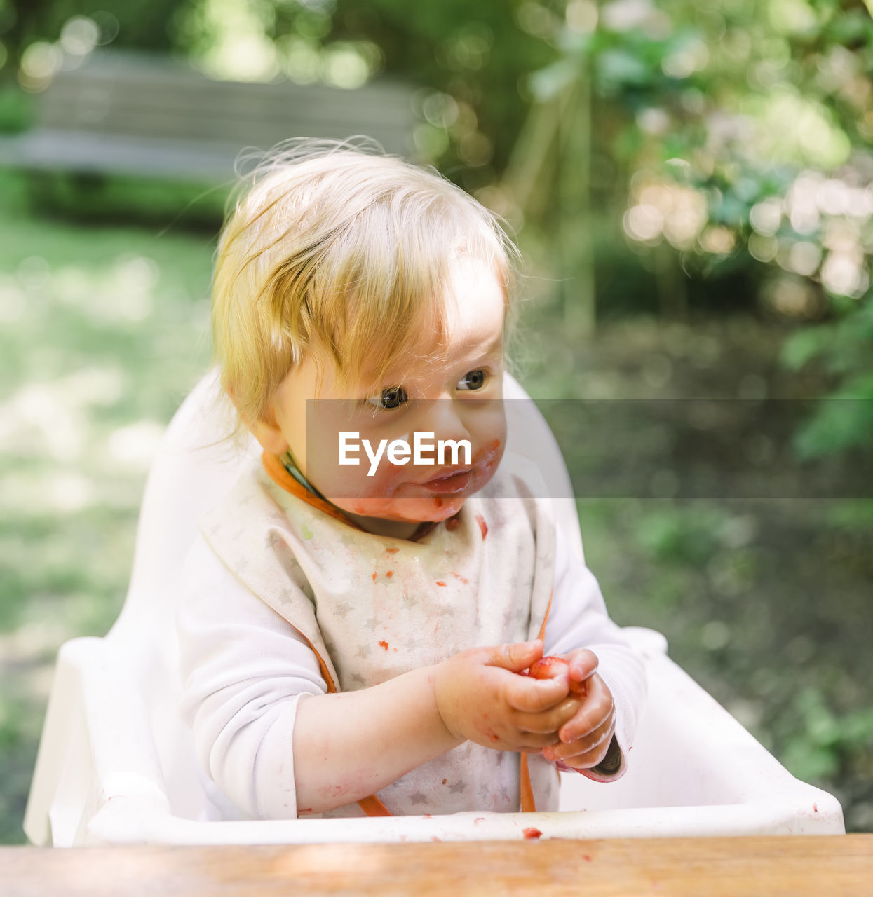 Cute boy eating fruits in garden