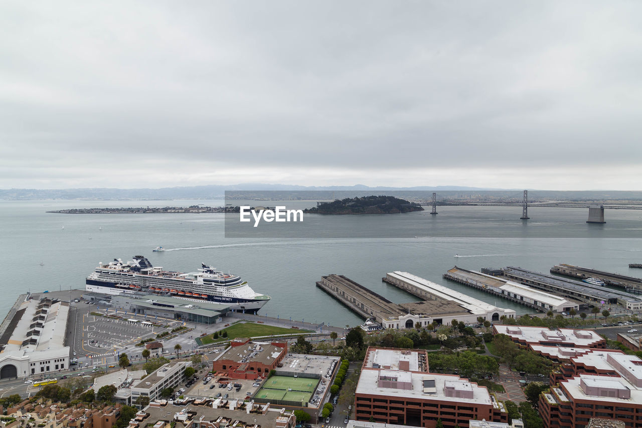 HIGH ANGLE VIEW OF HARBOR AGAINST SKY