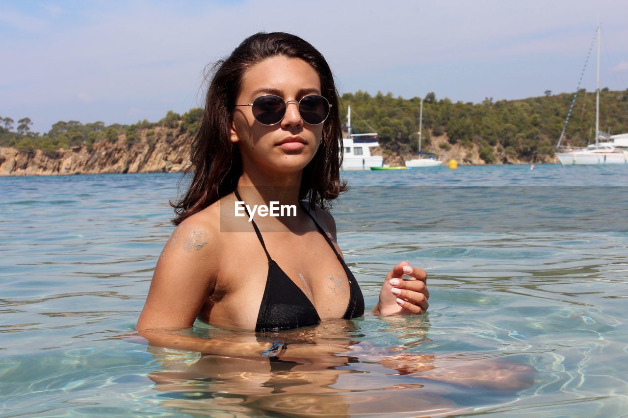 Portrait of young woman in water