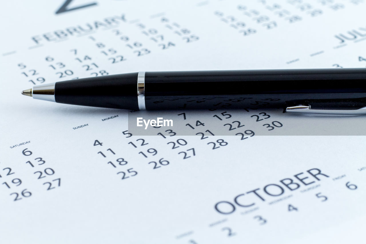 Close-up of pen on calendar