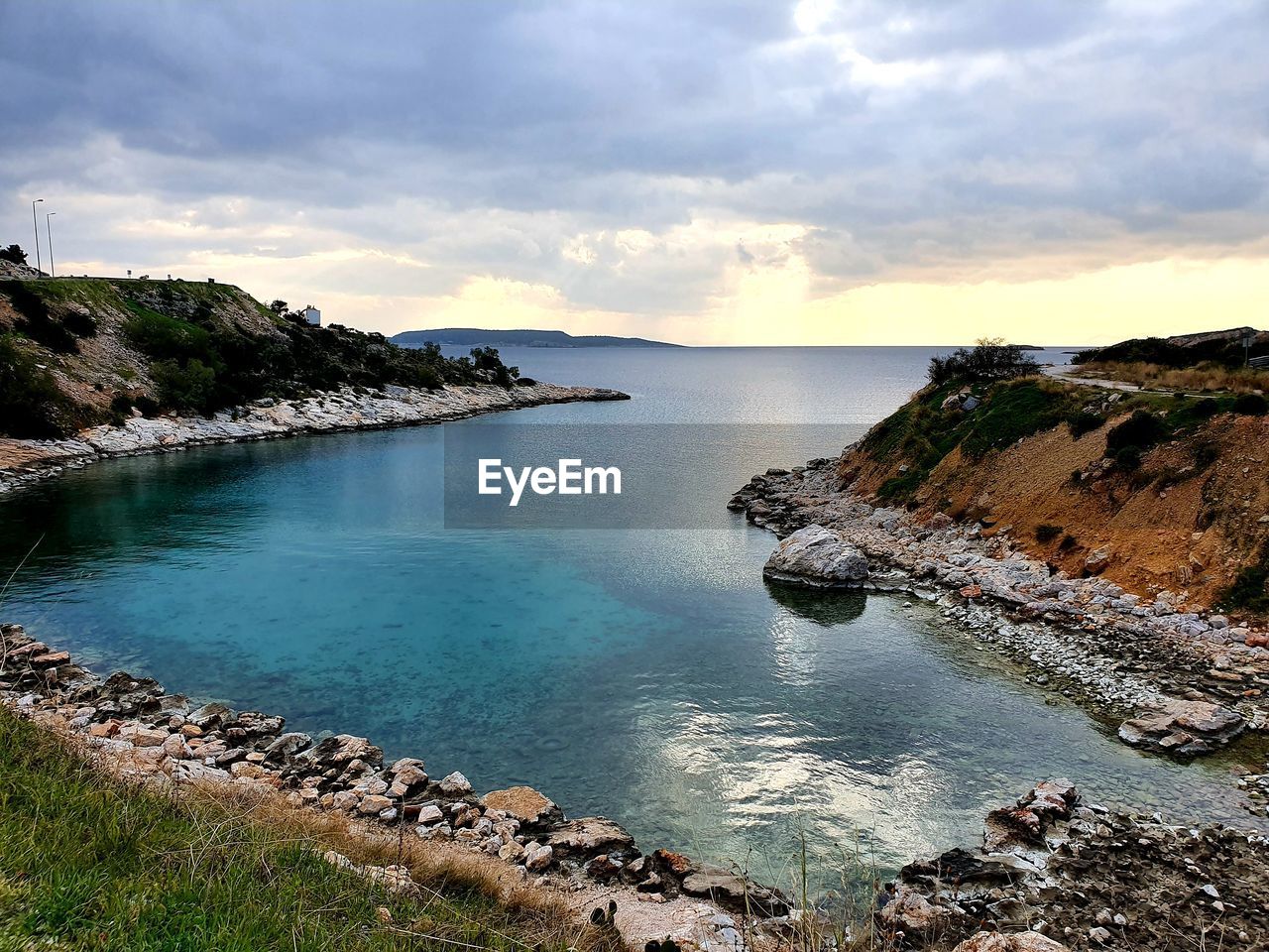 SCENIC VIEW OF SEA BY ROCKS AGAINST SKY