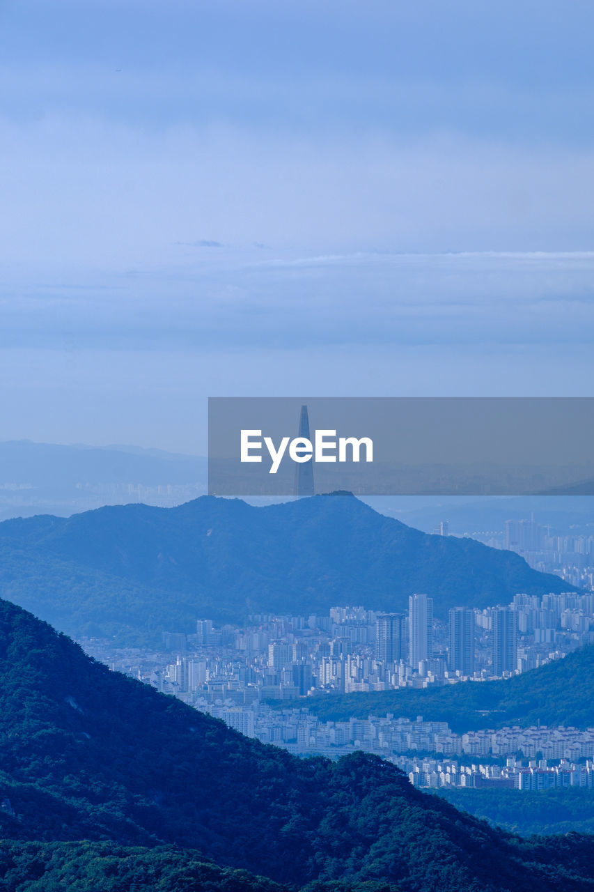 architecture, sky, horizon, mountain, scenics - nature, built structure, environment, nature, landscape, travel destinations, beauty in nature, building exterior, no people, cloud, travel, building, city, water, land, mountain range, fog, tourism, outdoors, sea, tranquility, tower, tranquil scene, blue, day, history, the past, cityscape