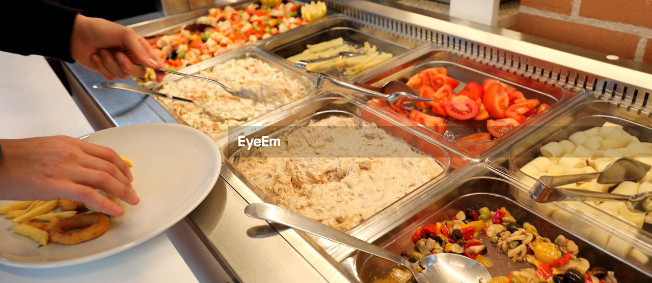 Inside a self service restaurant with raw and cooked foods