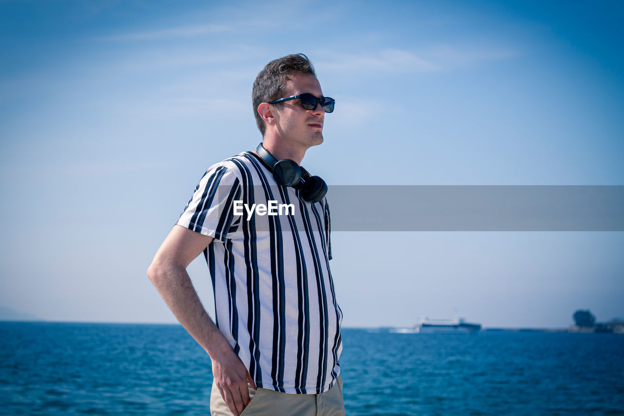 Man walking on the beach with his headphones