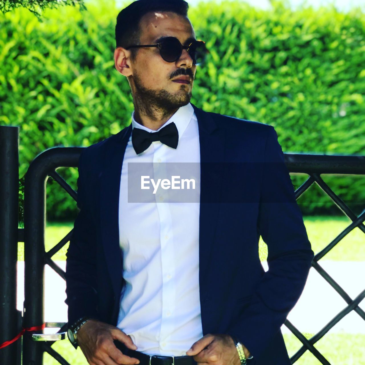 Young man wearing suit standing outdoors