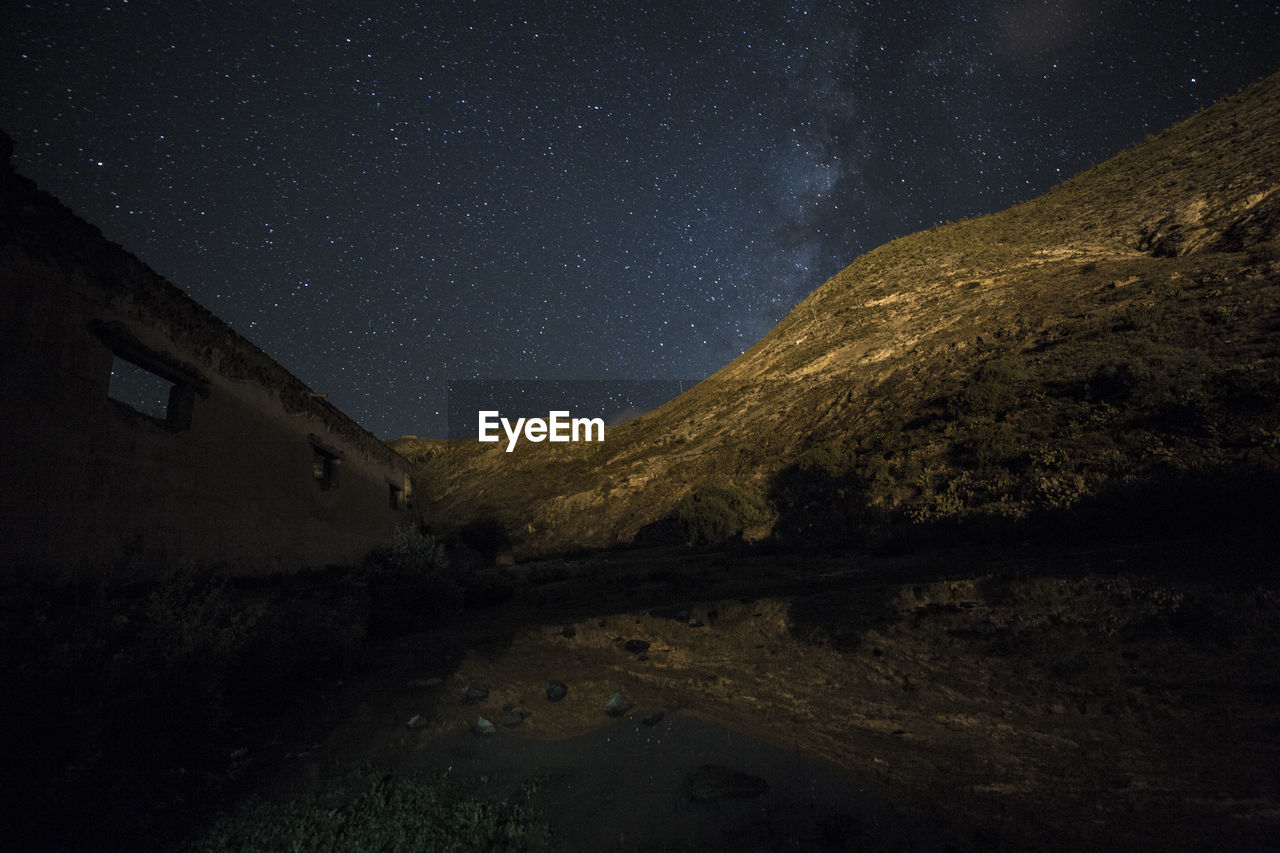 Scenic view of mountains against sky at night