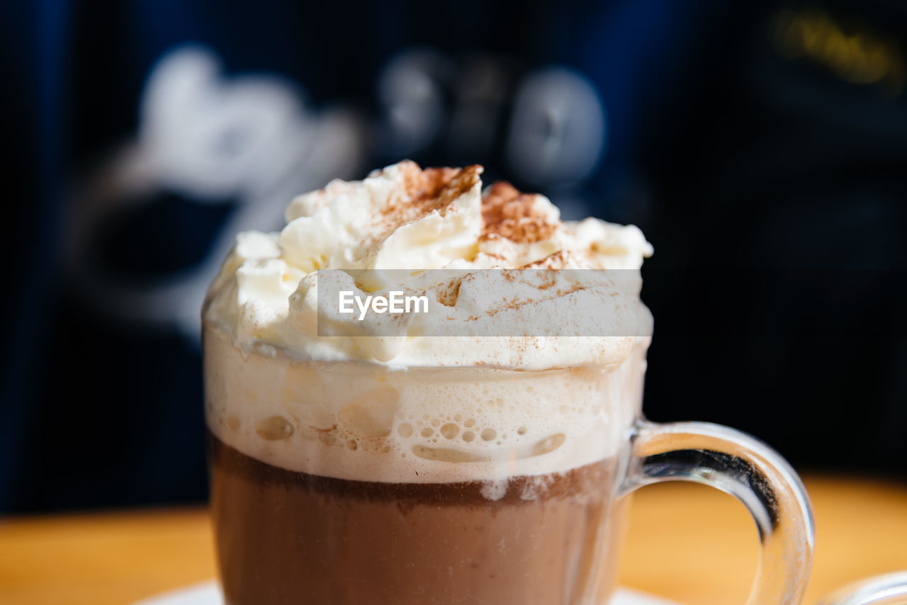 Close-up of cream on chocolate milkshake at cafe