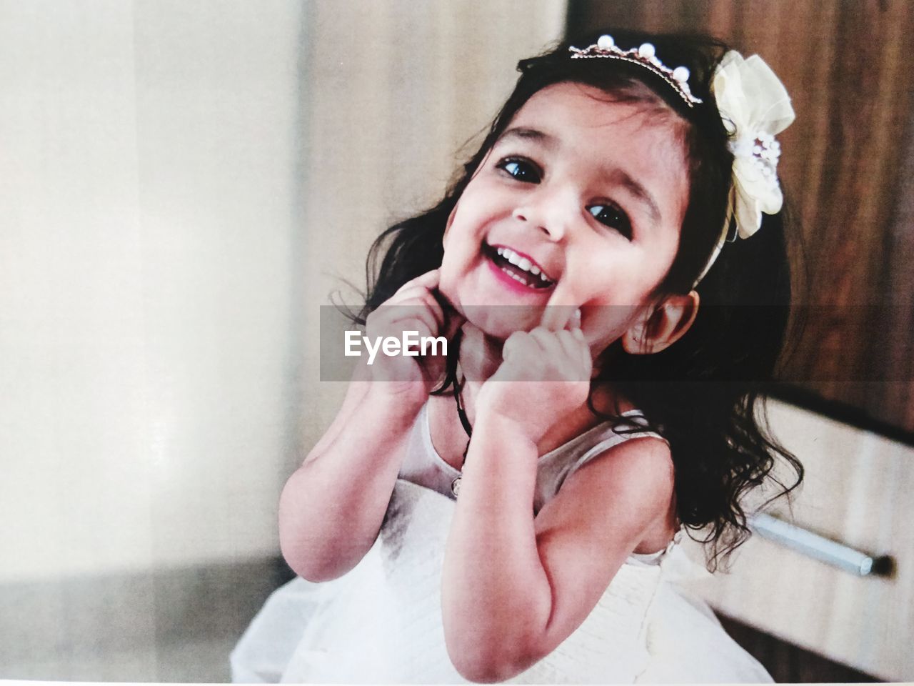 Portrait of smiling baby girl standing at home