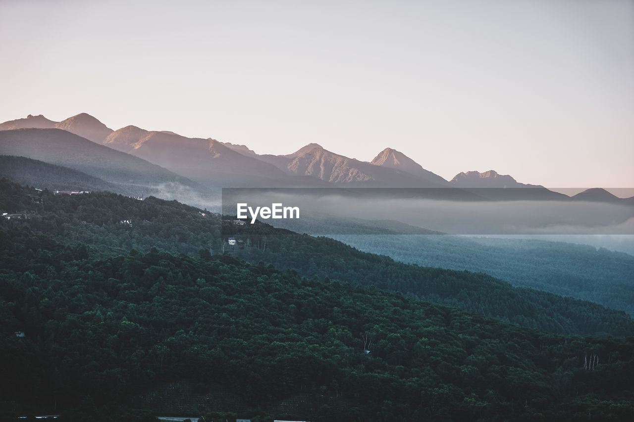 Scenic view of mountains against clear sky during sunset