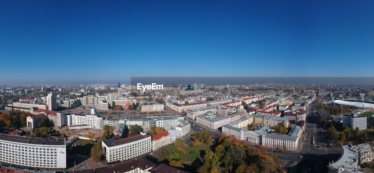 High angle view of buildings against blue sky