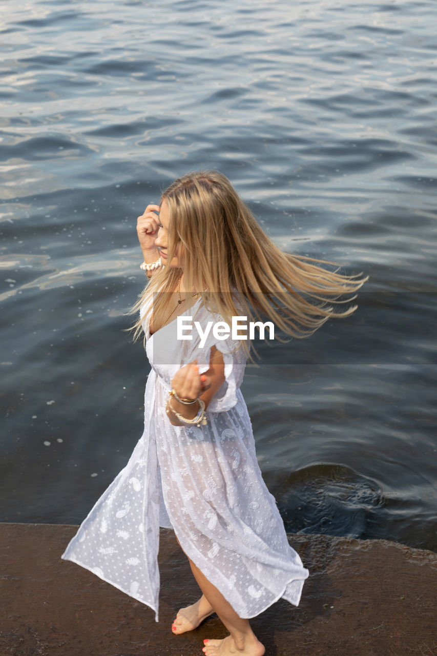 Young woman standing in water