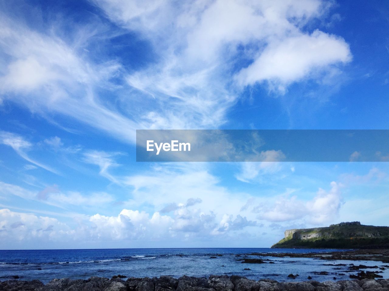 Scenic view of sea against cloudy sky