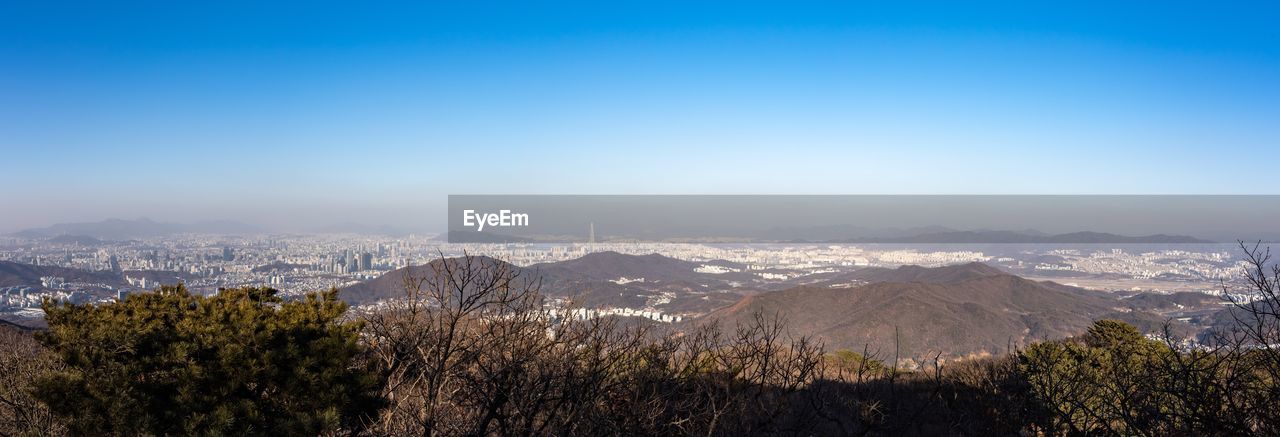 Panoramic view of landscape against blue sky