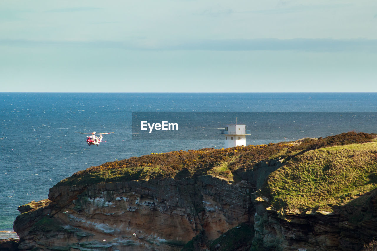 SCENIC VIEW OF SEA AND ROCKS AGAINST SKY