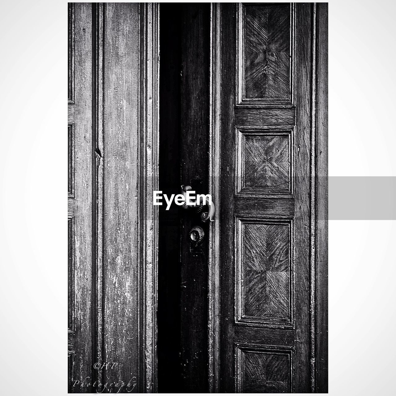 Close-up of door handle on wooden door