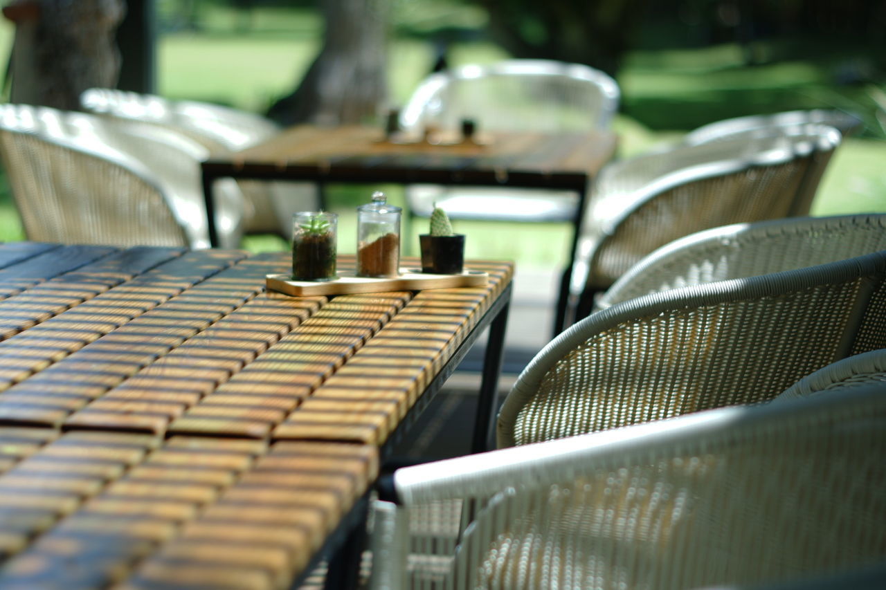 Empty chairs and tables in swimming pool