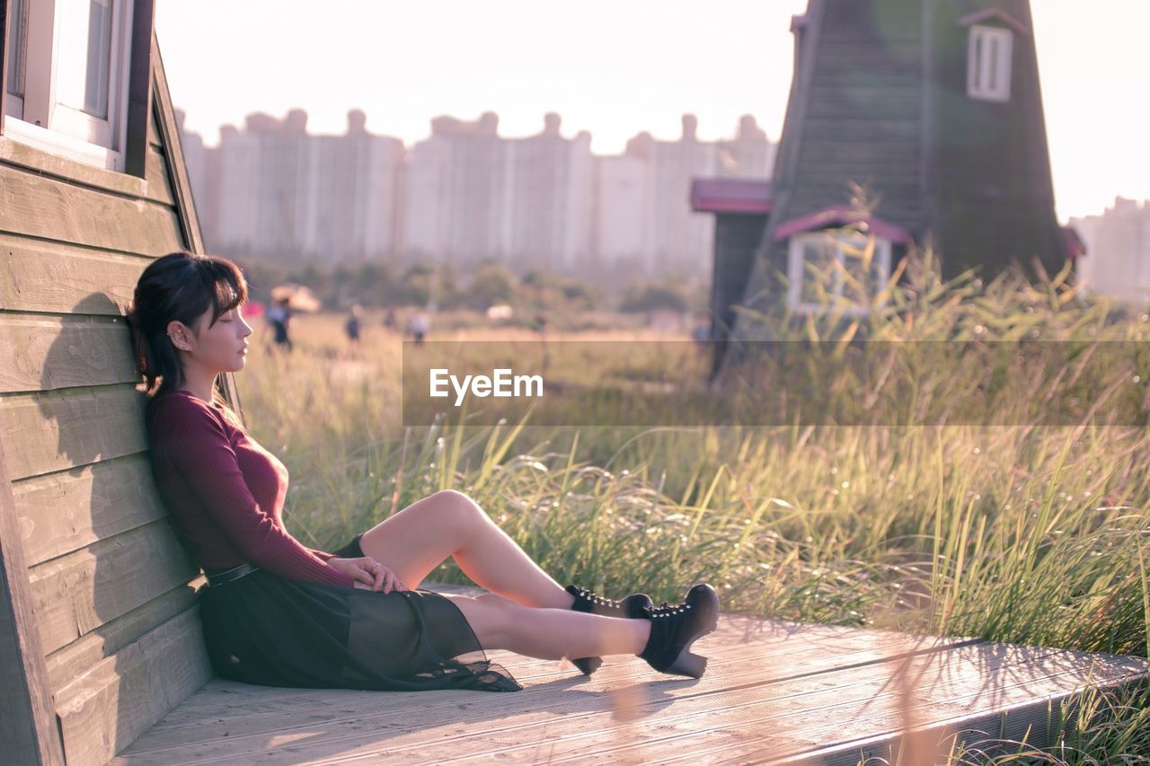 Young woman sitting outdoors