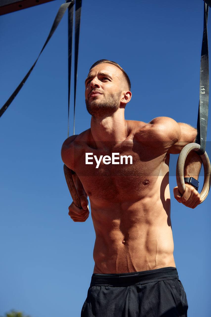 low angle view of man standing against clear sky