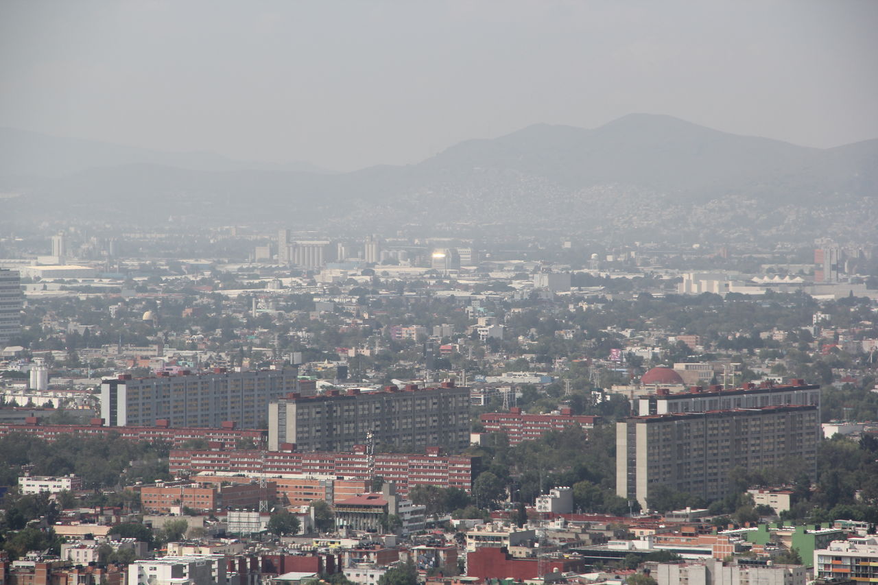 High angle view of buildings in city against clear sky