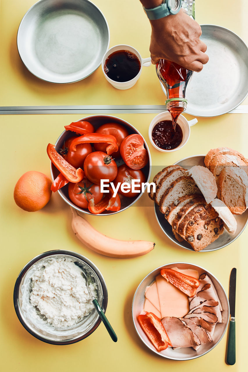 Breakfast prepared during summer vacation on camping. bread, cottage cheese, cold meat, tomatoes