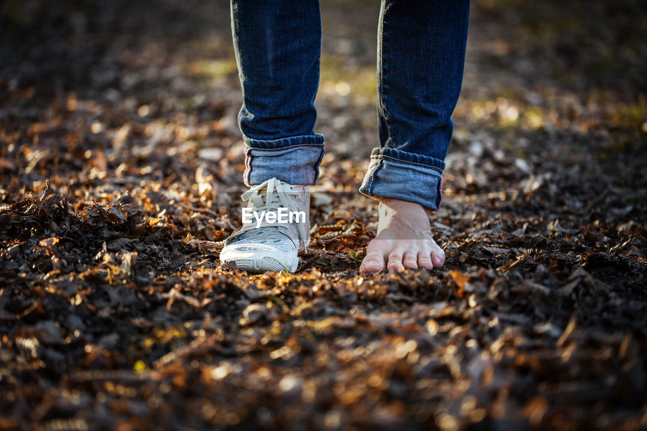 Low section of man standing on ground