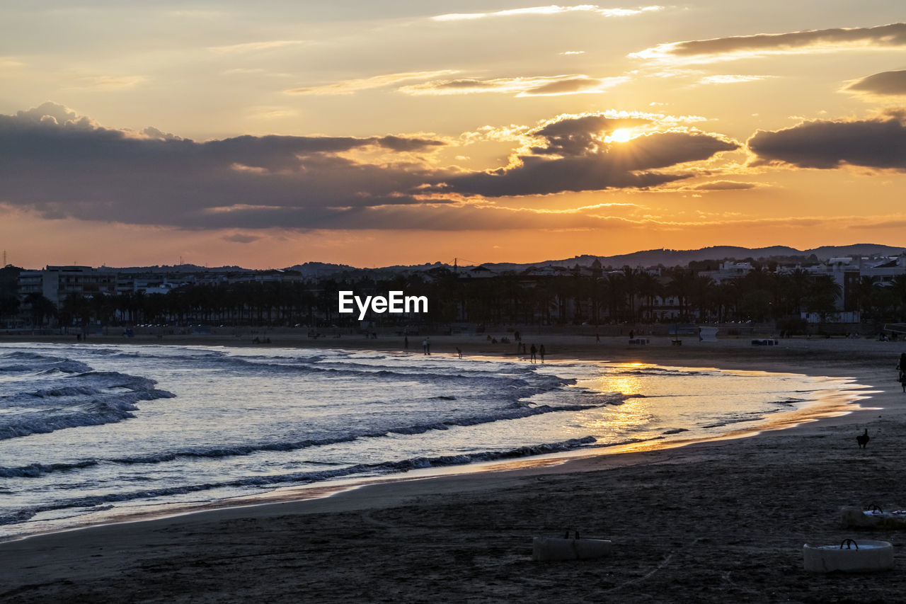 Scenic view of beach against sky during sunset